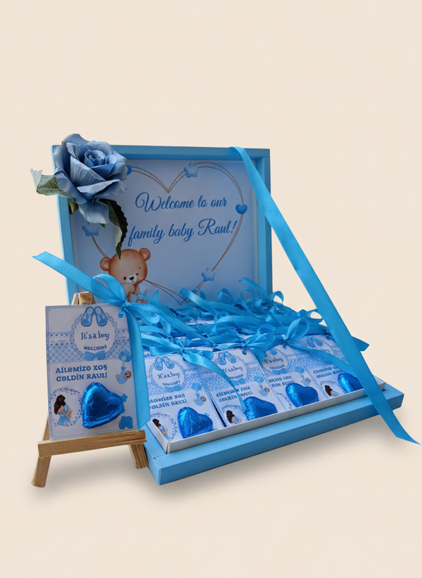Blue baby shower gift set with teddy bear and cards on a beige background