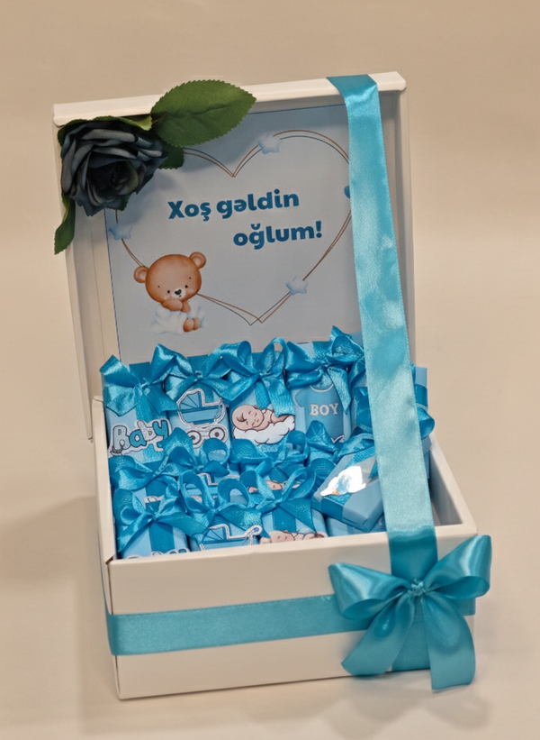 Gift box with blue candy and teddy bear design on a beige background