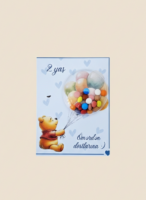 Card with a teddy bear and winnie the pooh holding balloons and candy chocolates and text on a beige background