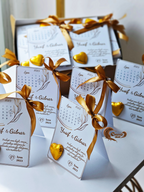 Calendar cards with gold ribbons and decorative elements on a white surface