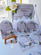Decorative cards with floral designs and heart-shaped objects on a white surface.