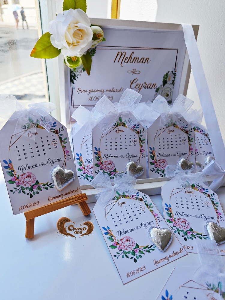 Decorative cards with floral designs and heart-shaped objects on a white surface.