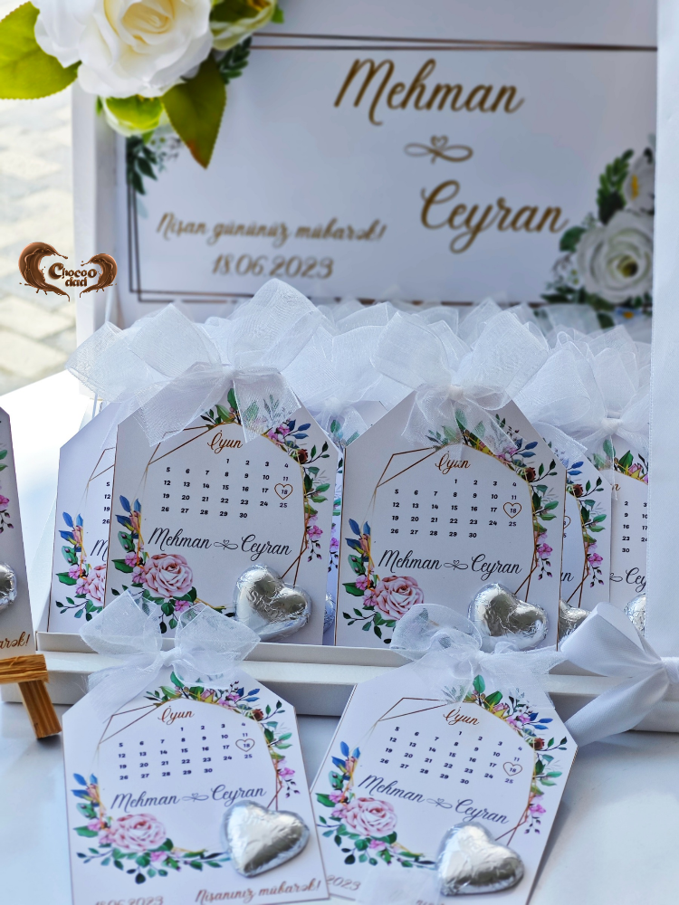 Decorative cards with floral designs and heart shapes, placed on a white surface with a floral background.