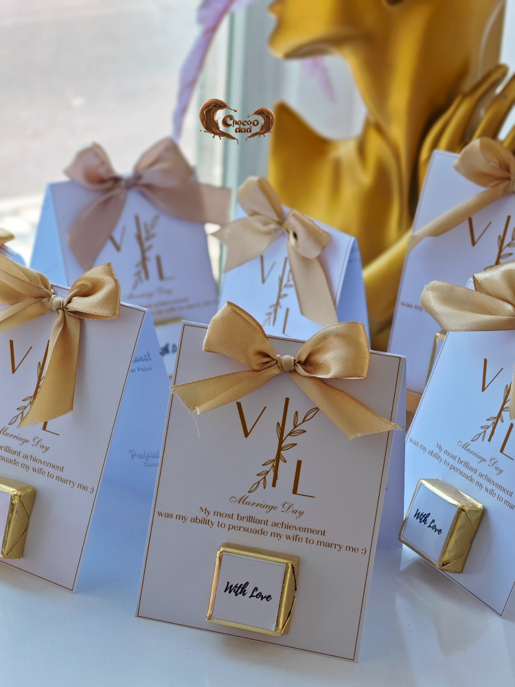 Gift boxes with gold ribbons and 'VL' branding on a white surface.