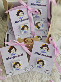 Set of 'Alice's first tooth' keepsake cards with a cartoon character on a soft surface.