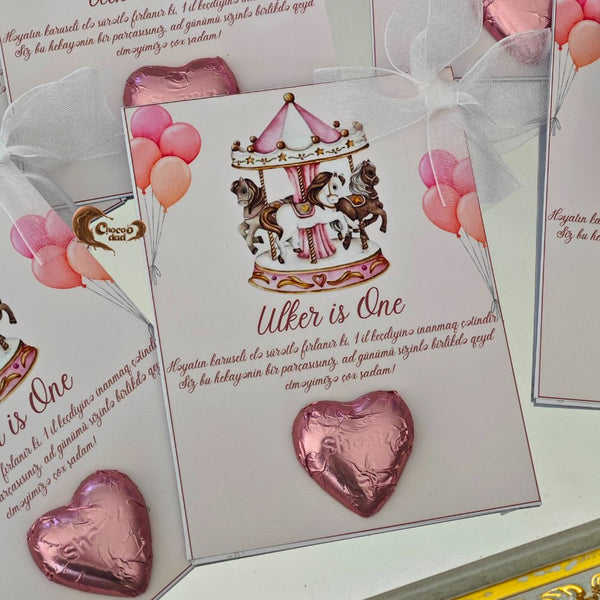Celebrate a beautiful first birthday with carousel watercolor clipart-designed chocolate cards. These delightful cards feature a soft, pastel watercolor carousel design, perfect for adding a whimsical touch to a girl's first birthday party
