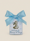 Gift box with a blue ribbon and a bunny illustration on a beige background