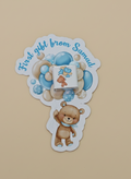 Sticker with teddy bear and text 'First gift from Samad' on a beige background