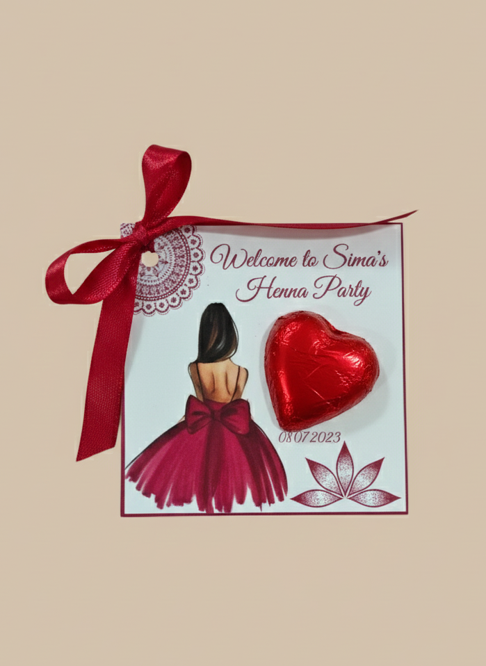 Henna party invitation with red ribbon, heart-shaped chocolate, and floral design on a beige background