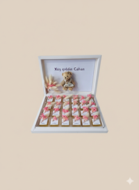 Gift box with teddy bear and small items on a beige background