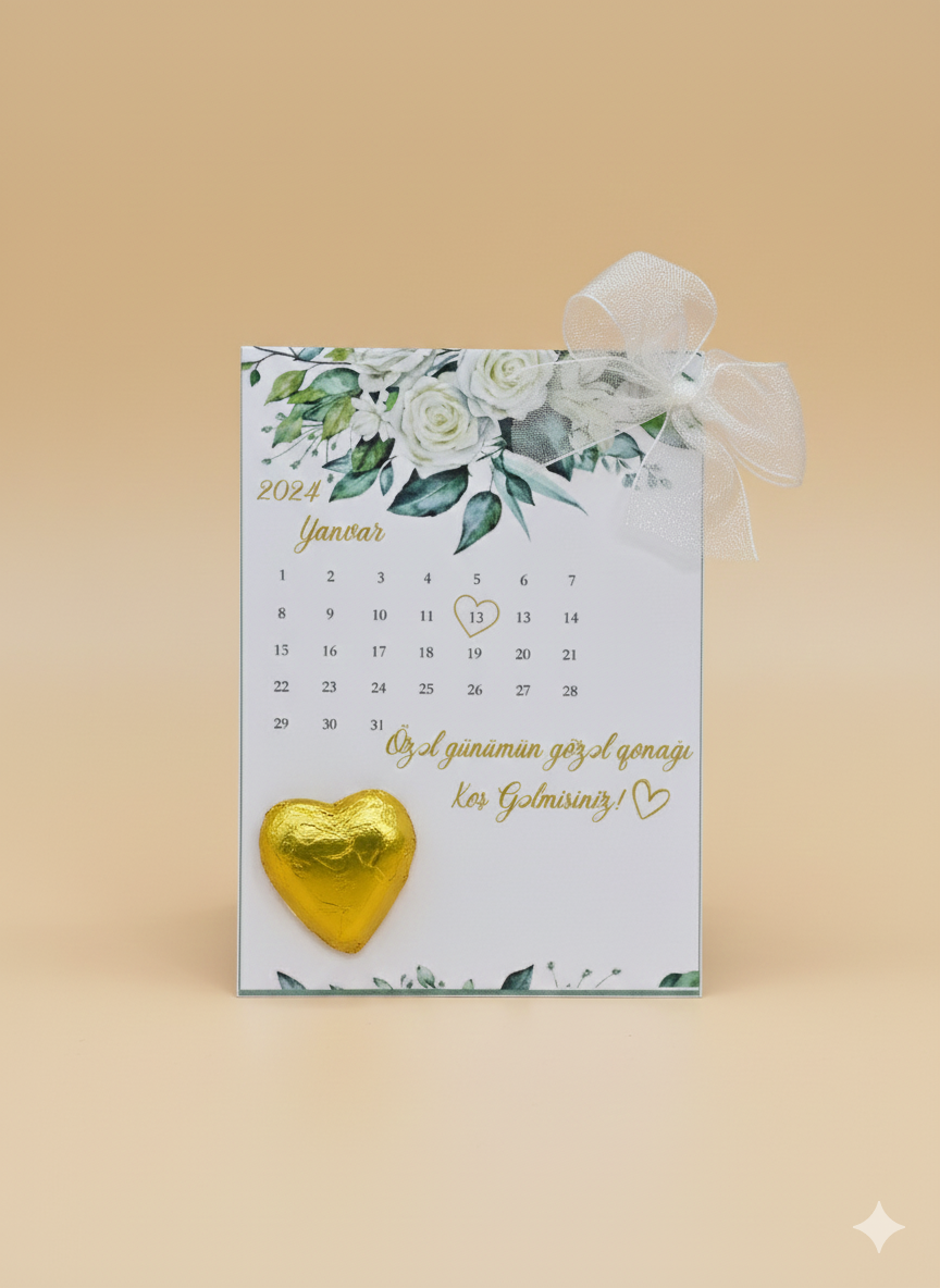 Calendar with floral design and gold heart-shaped chocolate on a beige background