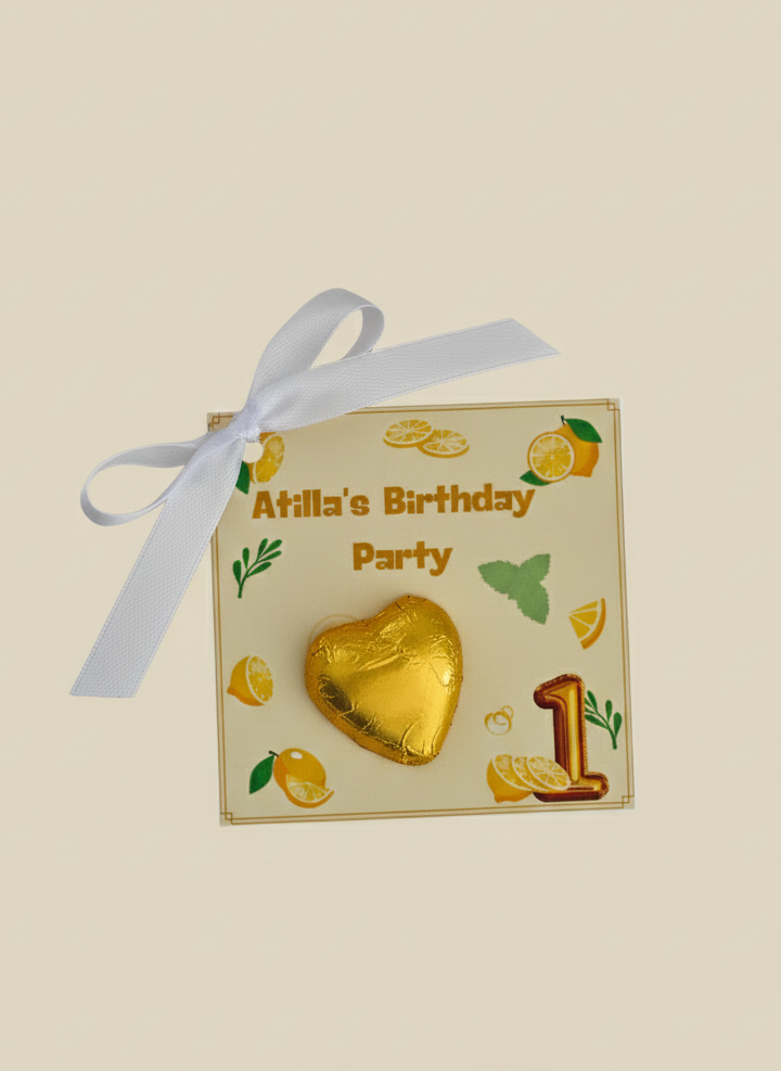 Gold heart-shaped candy with a white ribbon on a beige background