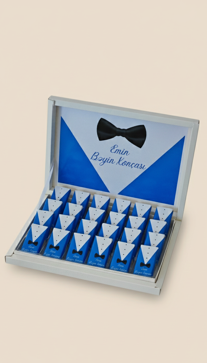 Box of small blue packages with a bow tie design on a beige background