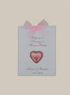 Invitation card for a Henna Party with a pink heart and bow on a light blue background