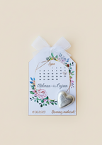 Decorative card with floral design and heart-shaped object on a beige background