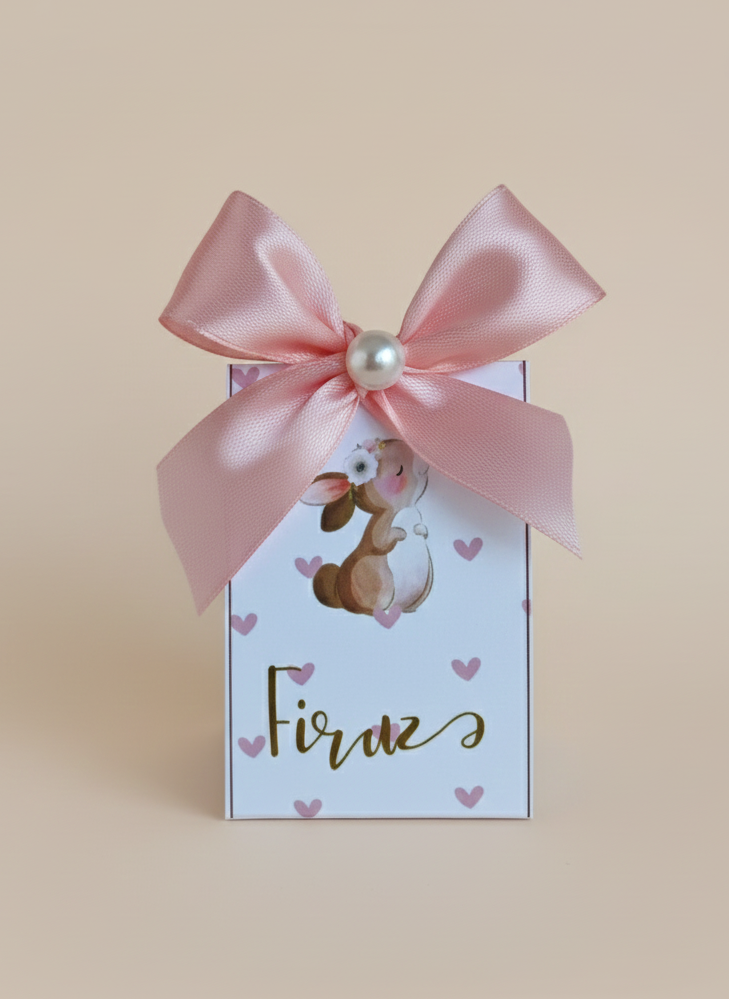 Gift box with pink ribbon and bunny illustration on a beige background