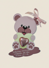Decorative bear with a heart and pink bow on a beige background