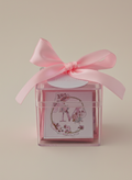 Gift box with pink ribbon and floral design on a beige background