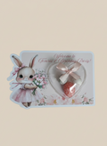 Decorative card with a rabbit illustration and heart-shaped box on a beige background