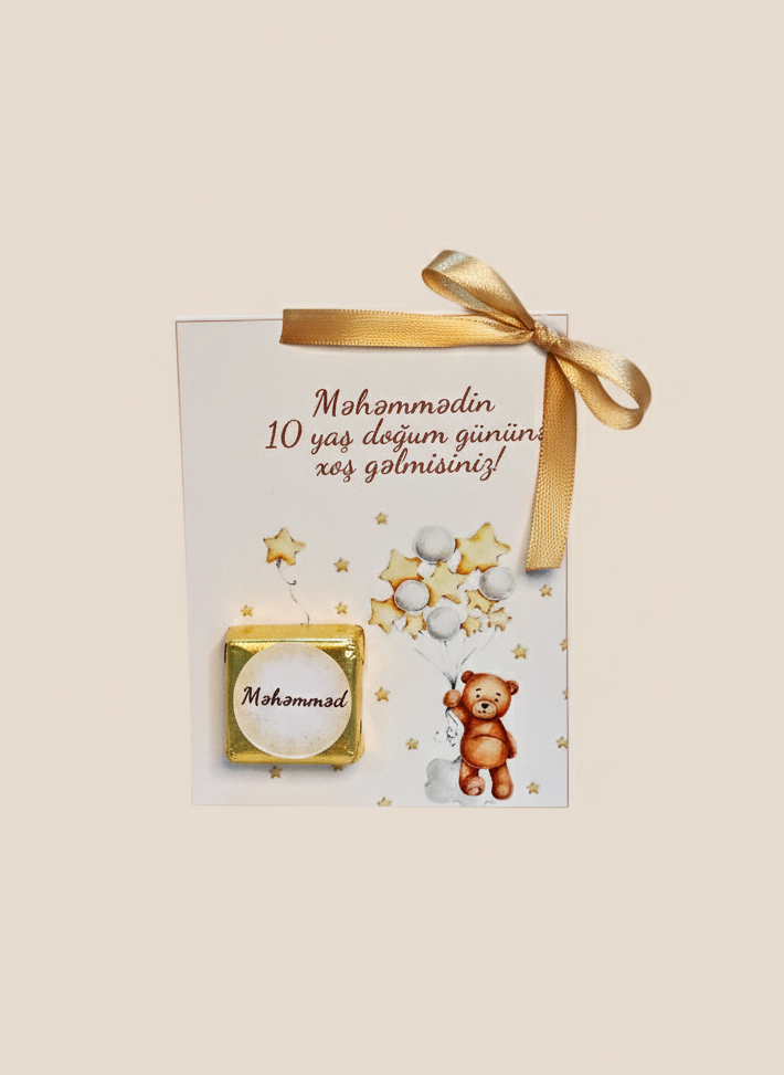 Gift box with a teddy bear and decorative elements on a beige background
