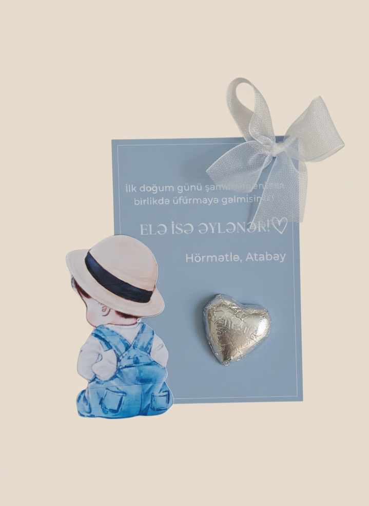 Heart-shaped brooch on a card with a child illustration, against a beige background