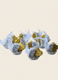 Decorative items with white antler-like structures and gold centers on a beige background