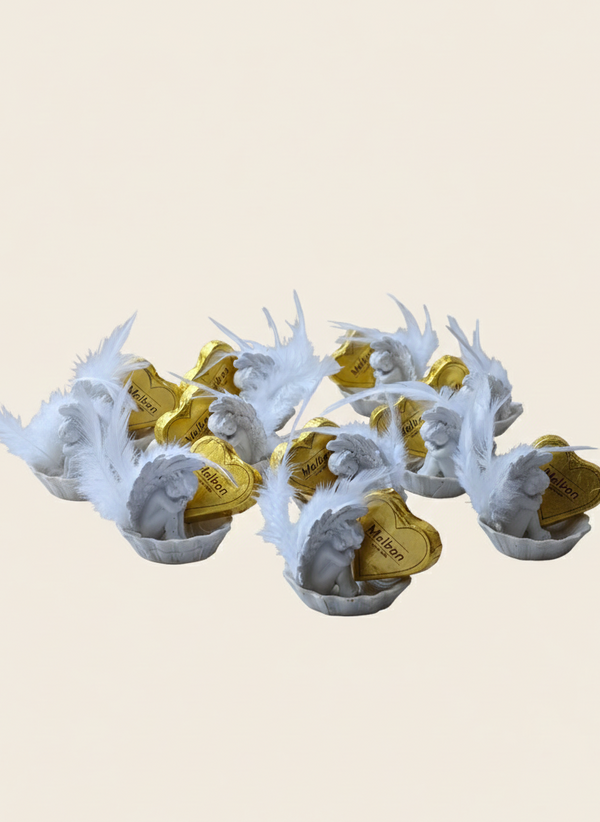 Decorative items with white antler-like structures and gold centers on a beige background