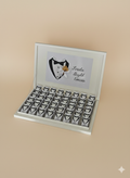 Set of heart-shaped boxes with a tuxedo design on a beige background