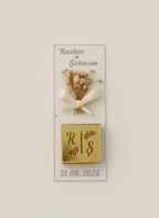 Decorative wall plaque with dried flowers, a bow, and personalized text on a light background