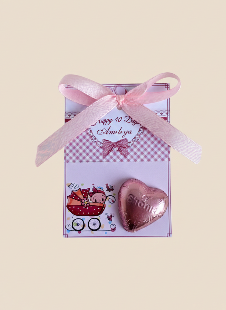 Pink heart-shaped gift with ribbon and decorative card on a beige background