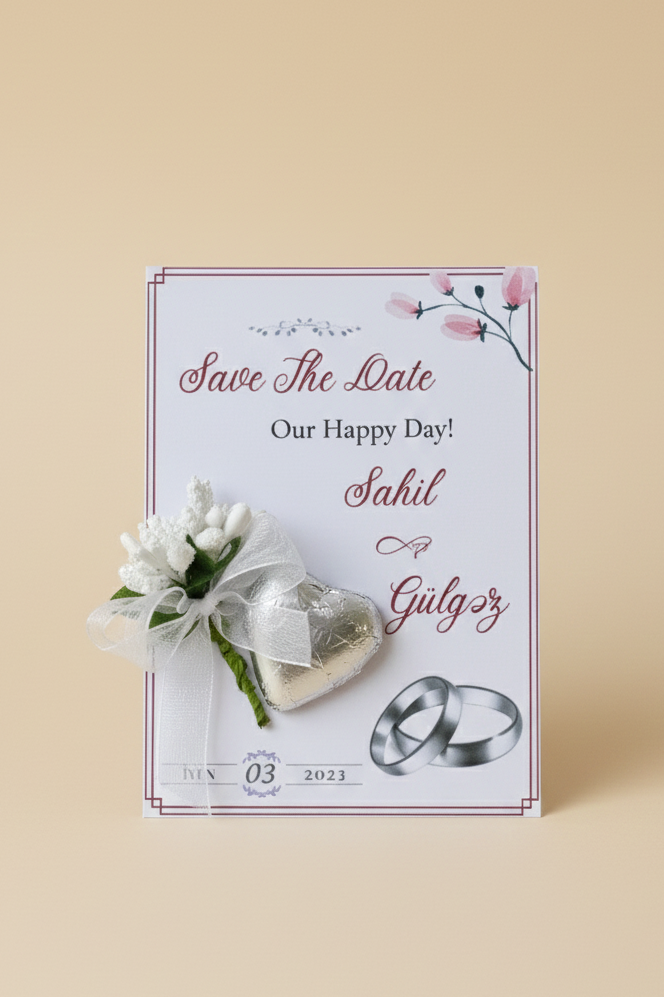 Save the Date card with wedding rings and flowers on a beige background