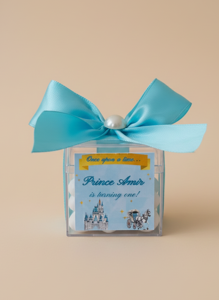 Gift box with blue ribbon and 'Prince Amir' label on a beige background