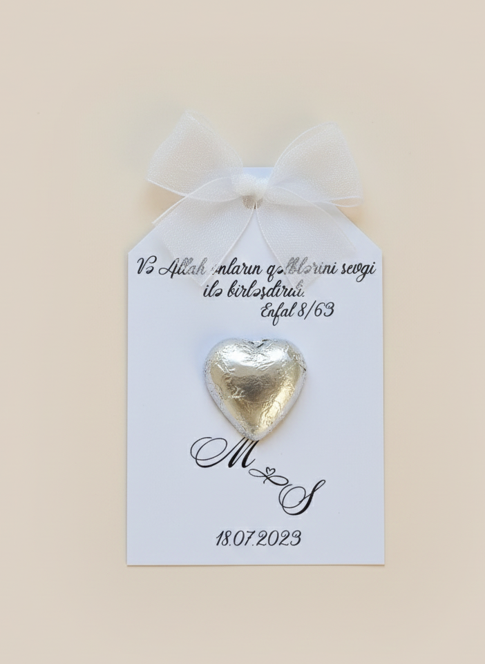 Gold heart-shaped chocolate on a card with personalized text on a beige background