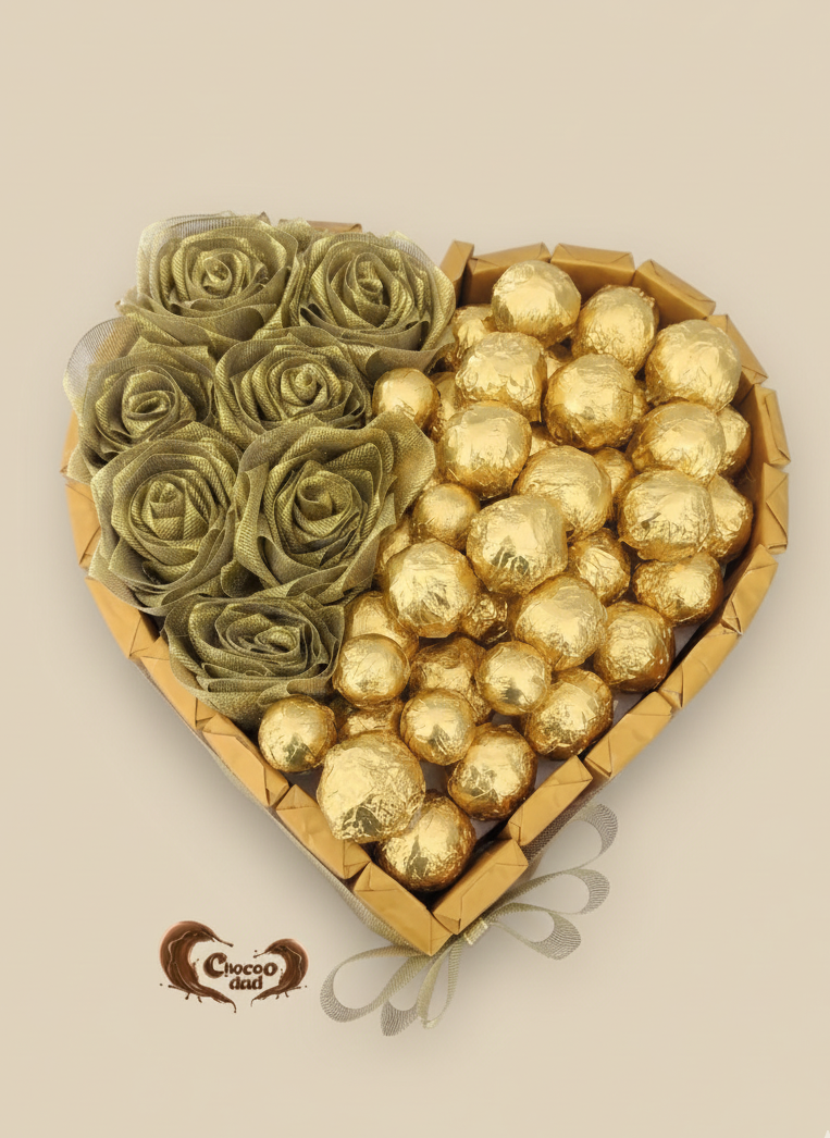 Heart-shaped box with green roses and gold Ferrero Rocher chocolates on a beige background
