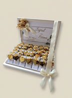 Decorative box with gold and white flowers on a beige background