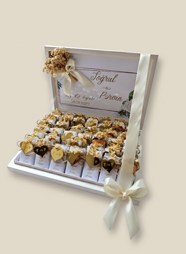 Decorative box with gold and white flowers on a beige background