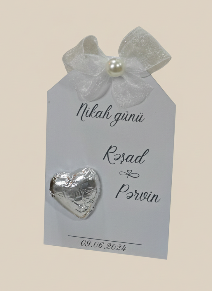 Decorative card with a heart-shaped object and ribbon on a beige background