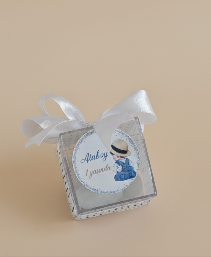 Small decorative box with a ribbon on a beige background