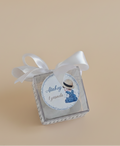 Small decorative box with a ribbon on a beige background