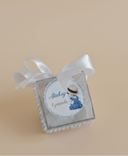 Small decorative box with a ribbon on a beige background