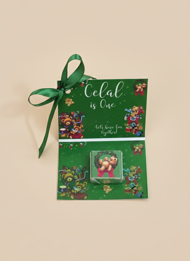 Green gift bag with floral design and ribbon on a beige background