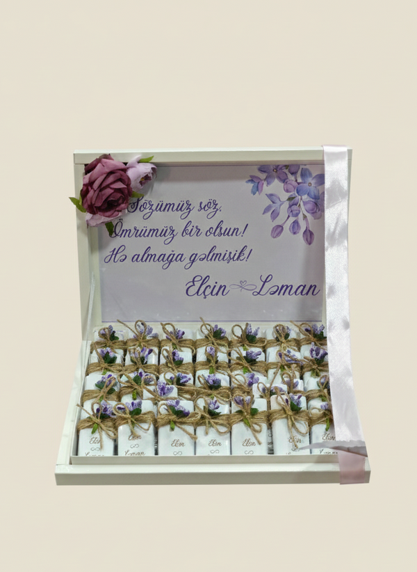 Packaged chocolates with floral design and text on a beige background