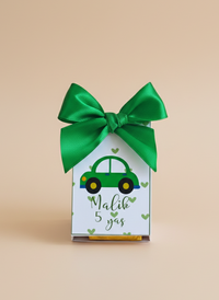 Gift box with green car design and bow on a beige background