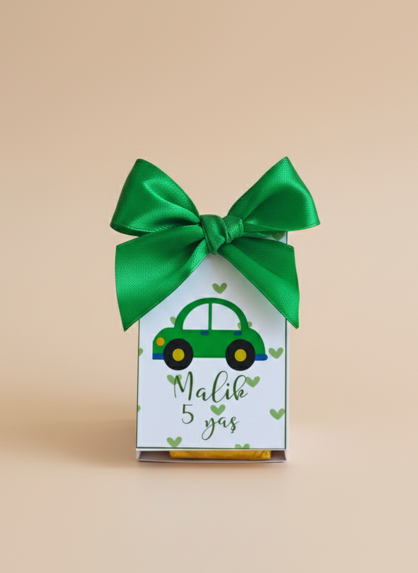 Gift box with green car design and bow on a beige background