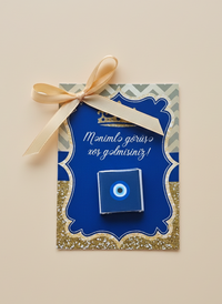 Blue decorative box with a gold bow on a beige background