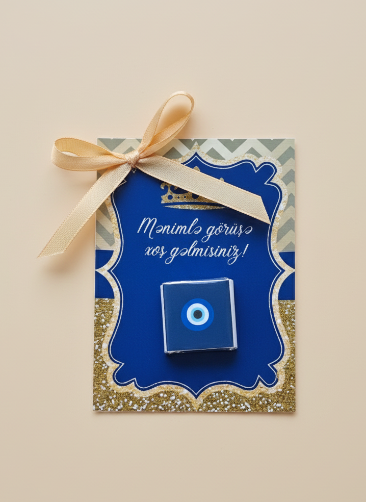 Blue decorative box with a gold bow on a beige background