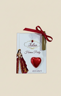 Henna party invitation with a red ribbon on a beige background