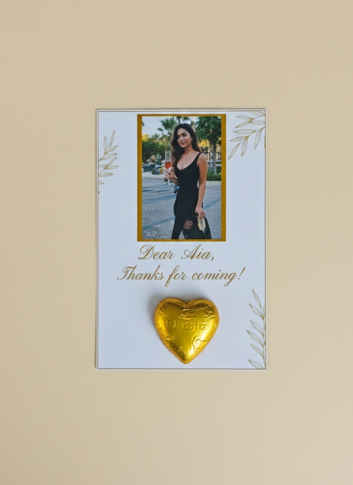 Gold heart-shaped chocolate on a card with a photo of a woman and text on a beige background