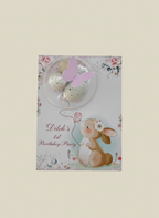 Children's birthday party invitation with bunny and balloons on a floral background
