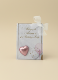 Gift box with pink heart and white bow on a beige background